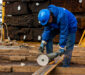 worker cuts iron with tool